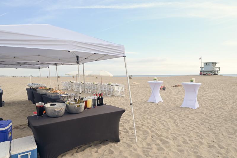 Beachfront welcome reception at golden hour